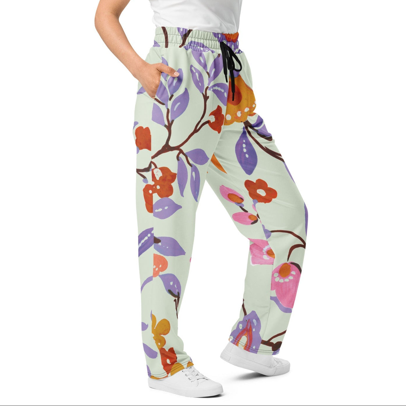 A model wearing The Sloane Square Flow Wide Joggers, showing the relaxed, wide-leg cut and the oversized pink and lilac floral print.