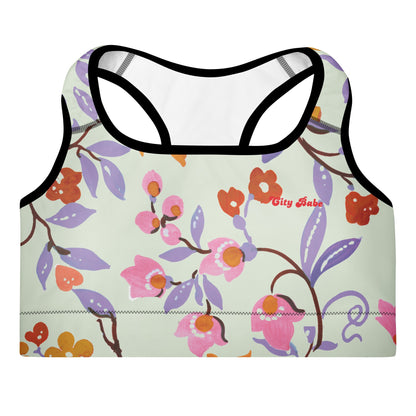 A close-up of The Sloane Square Performance Bra, highlighting the soft recycled fabric and the elegant pastel pink and lilac floral print.