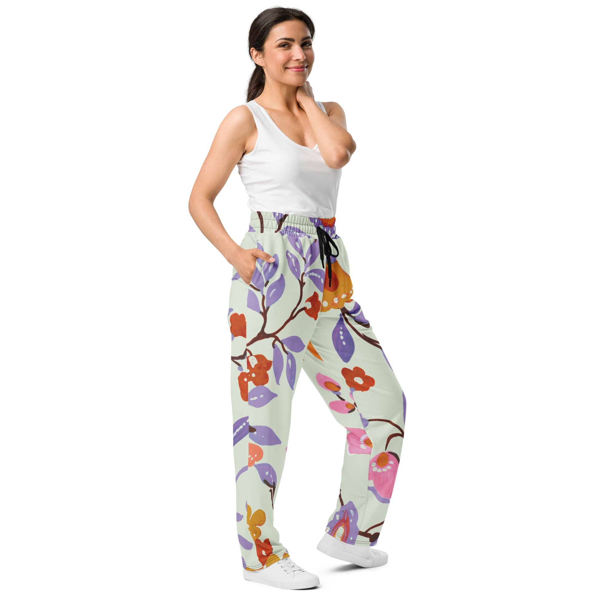 A model wearing The Sloane Square Flow Wide Joggers, showing the relaxed, wide-leg cut and the oversized pink and lilac floral print.