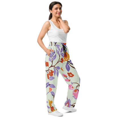 A model wearing The Sloane Square Flow Wide Joggers, showing the relaxed, wide-leg cut and the oversized pink and lilac floral print.