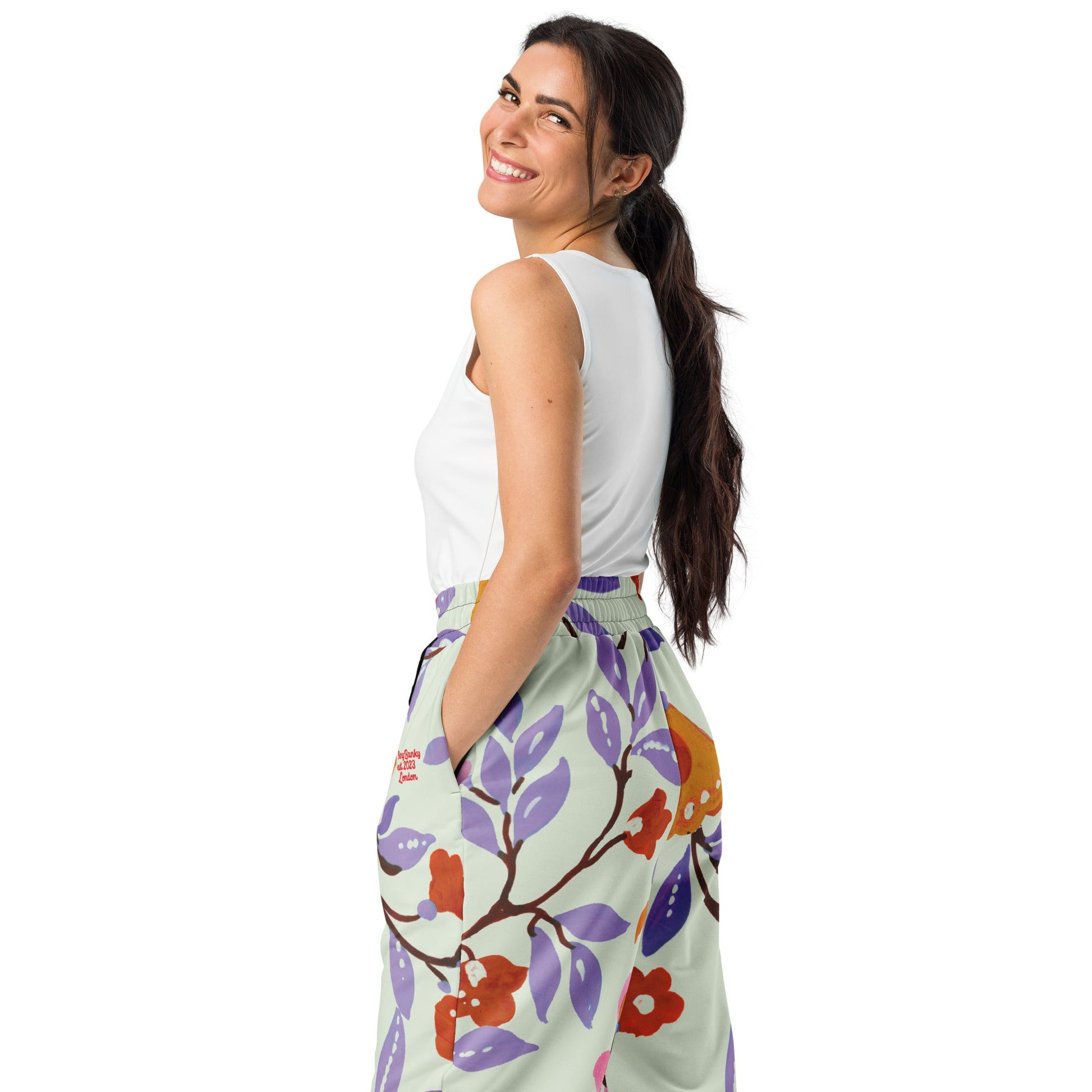 A close-up of The Sloane Square Flow Wide Joggers, highlighting the soft texture and the elegant pastel pink and lilac oversized floral print.