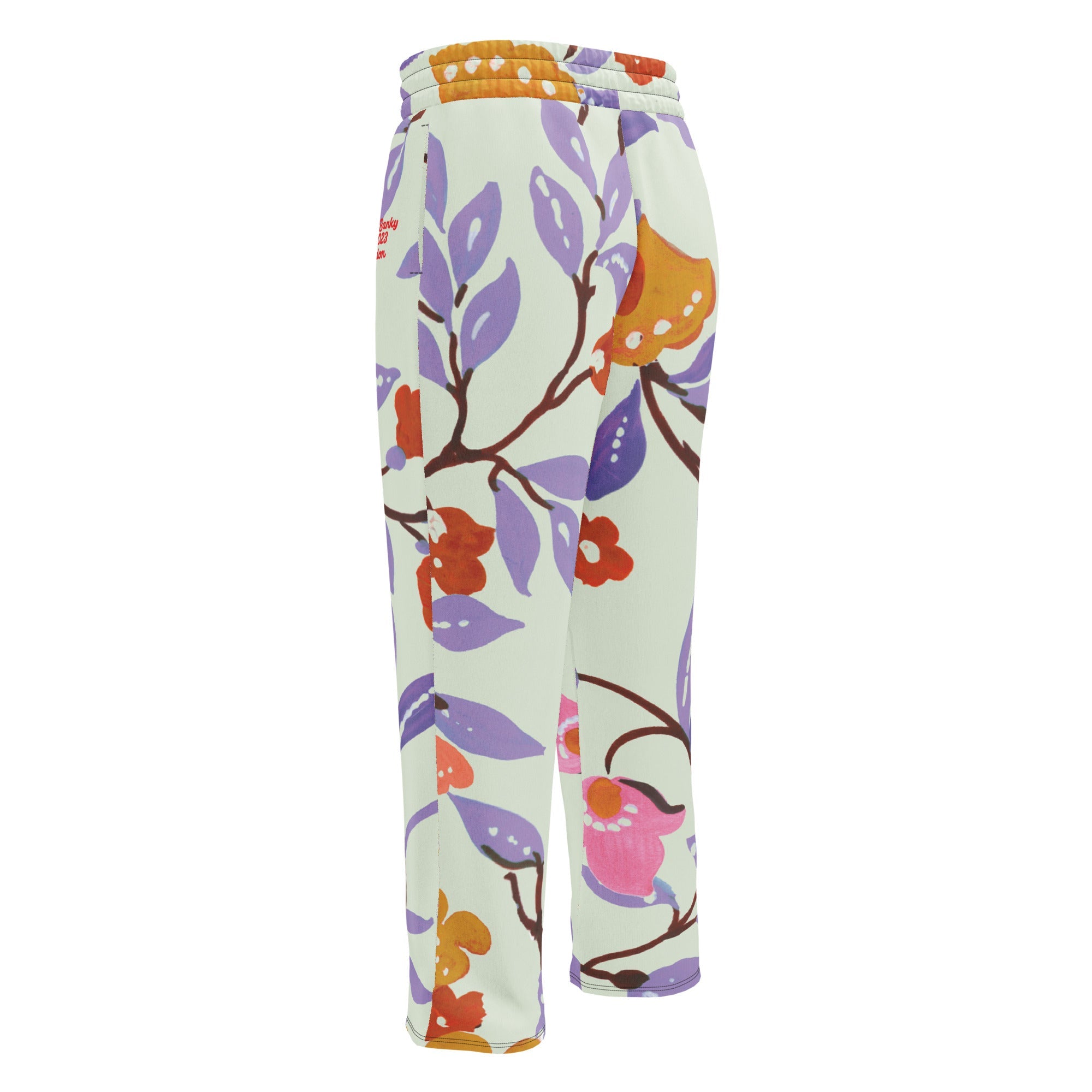 A close-up of The Sloane Square Flow Wide Joggers, highlighting the soft texture and the elegant pastel pink and lilac oversized floral print.