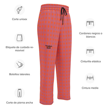 A close up of The Southwark Flow Wide Joggers, showing the relaxed, wide-leg cut and the orange on lilac print.