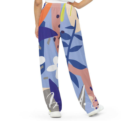 Model wearing the Surrey Flow Joggers featuring a vibrant floral print and lilac and blue hues highlighting the wide leg cut and relaxed fit with side pockets and adjustable waist.