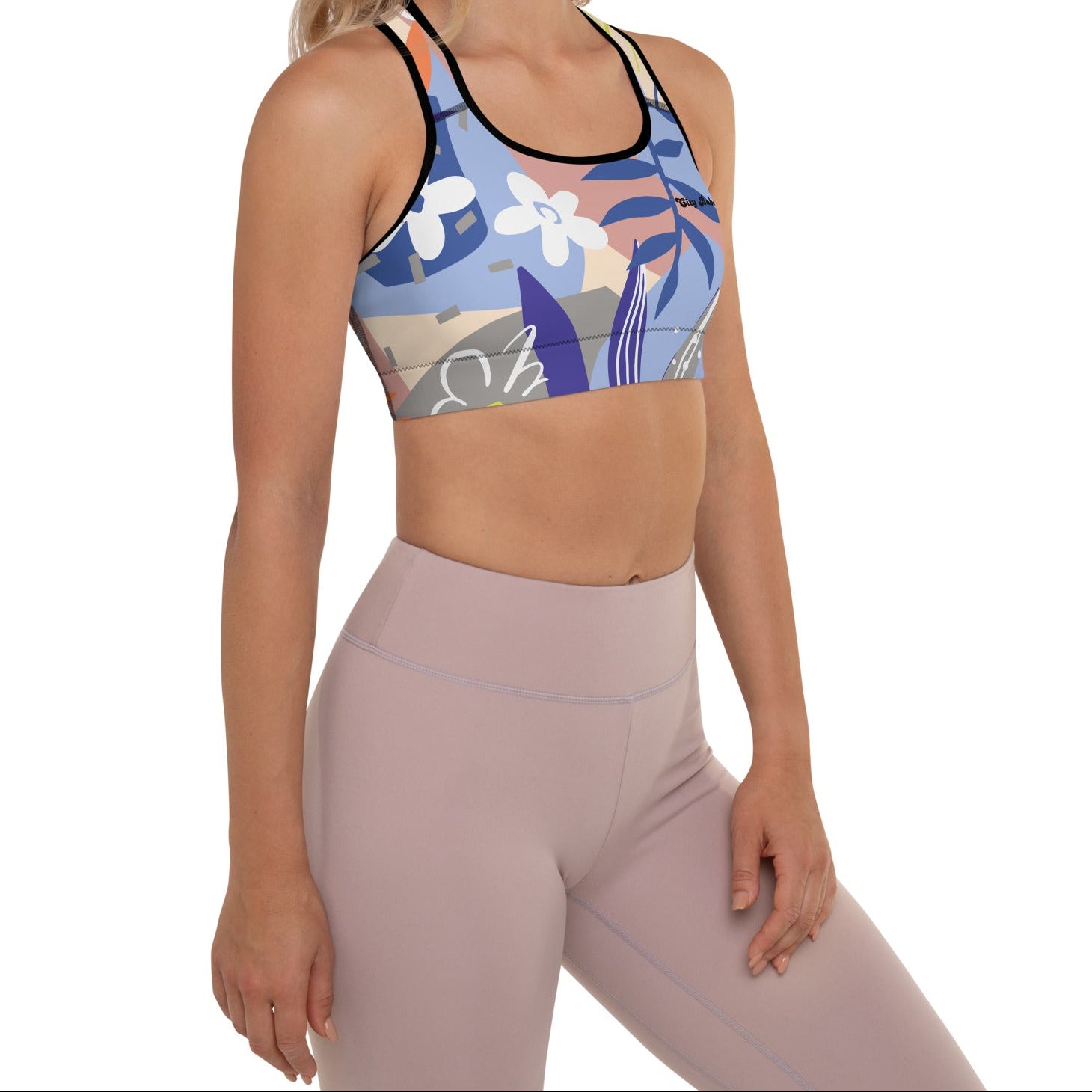 A model wearing the surrey performance bra with the print city babe on a floral print with lilac and beige hues