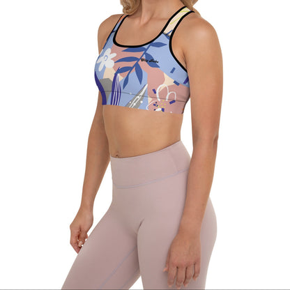 A model wearing the surrey performance bra with the print city babe on a floral print with lilac and beige hues