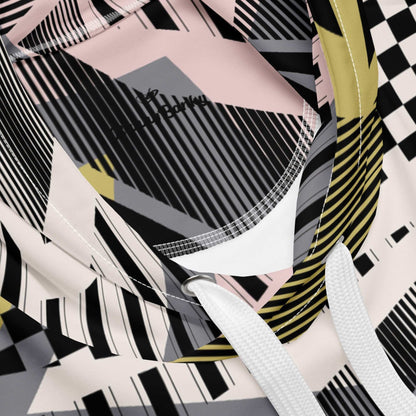 A close up of the Sydney Hoodie. The image highlights the Art Deco-inspired pattern of checkers and pinstripes in soft pink, sand, and olive tones, featuring red London branding.