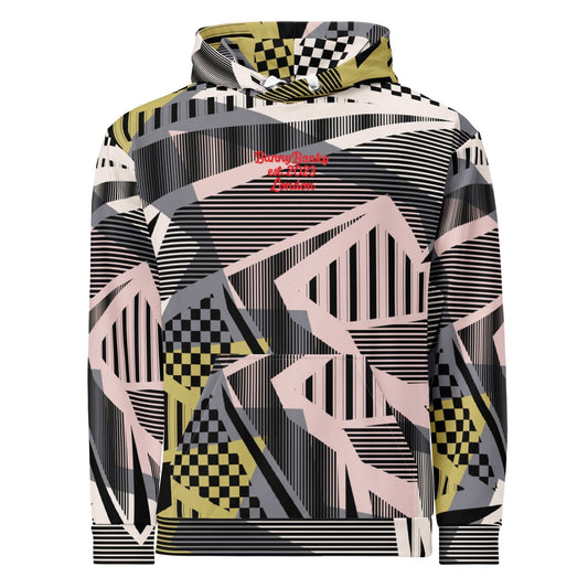 A close up of the Sydney Hoodie. The image highlights the Art Deco-inspired pattern of checkers and pinstripes in soft pink, sand, and olive tones, featuring red London branding.