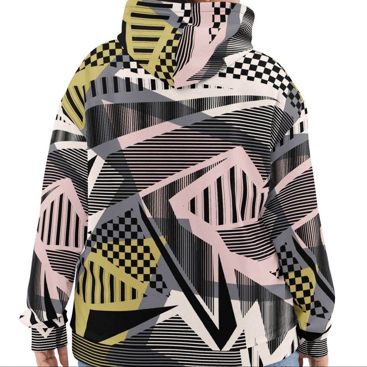 A model wearing the Sydney Hoodie. The image highlights the Art Deco-inspired pattern of checkers and pinstripes in soft pink, sand, and olive tones, featuring red London branding.