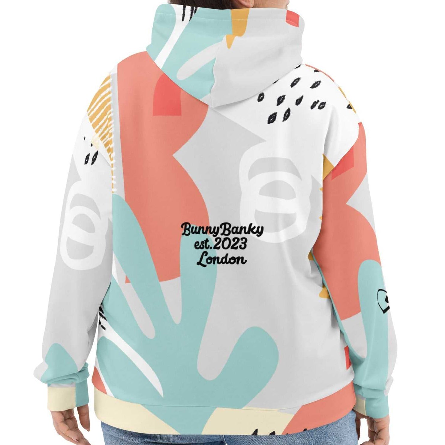 Close-up of the Terra Resort Hoodie on a model. The image focuses on the intricate earth-tone patterns and the soft, high-quality finish of the recycled brushed fleece fabric.