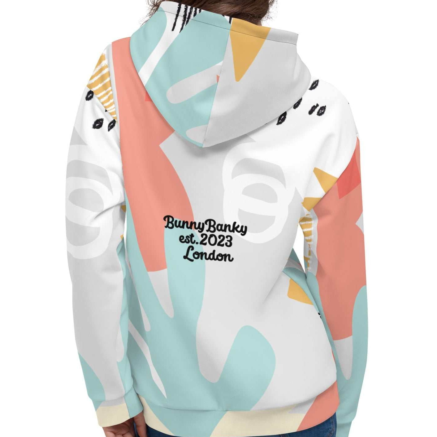 Close-up of the Terra Resort Hoodie on a model. The image focuses on the intricate earth-tone patterns and the soft, high-quality finish of the recycled brushed fleece fabric.