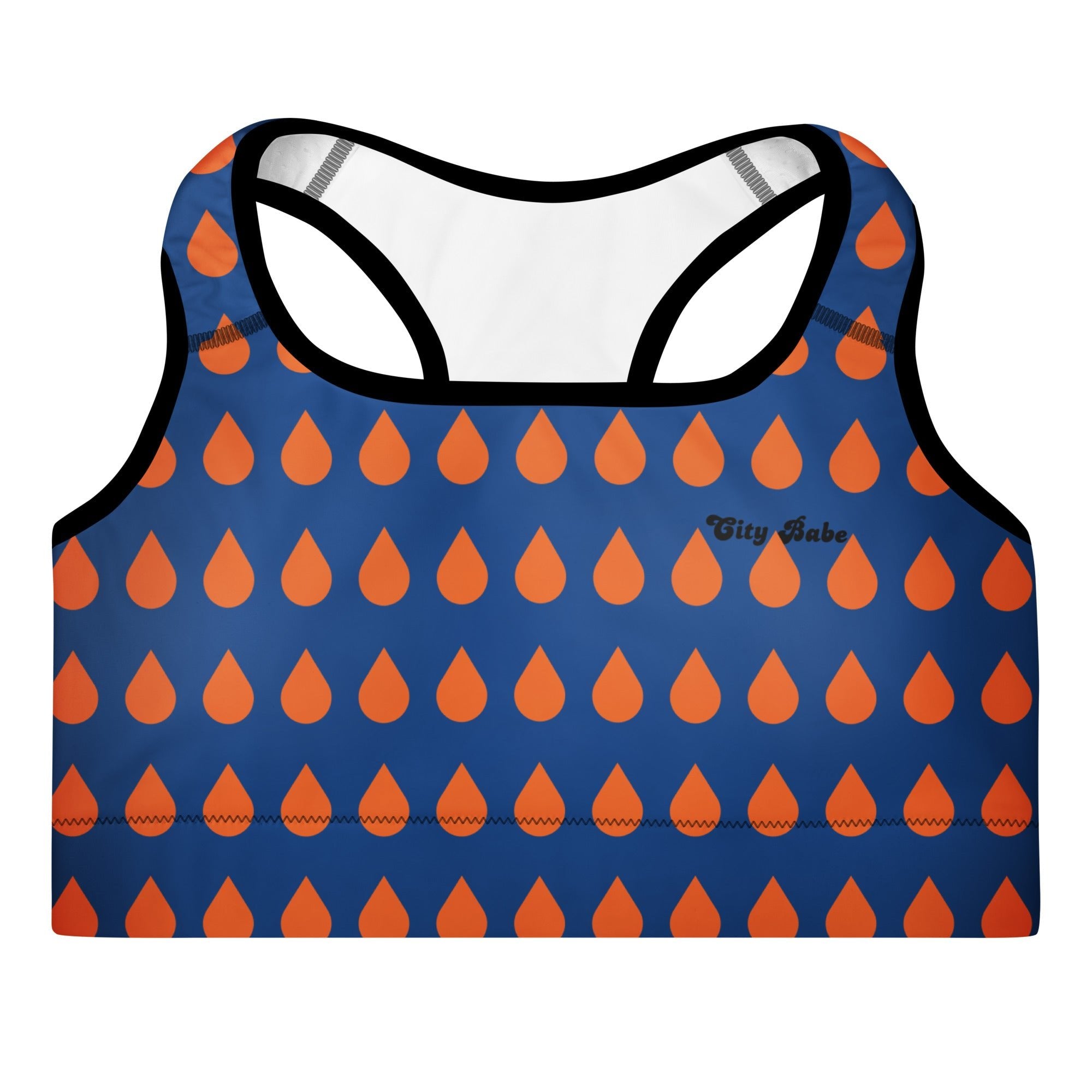 Close-up of the Thames Performance Bra, showing the supportive fit and the sophisticated orange drops print on the deep navy blue background. Highlights the garment's construction and the text City Babe printed in black on the top front left.
