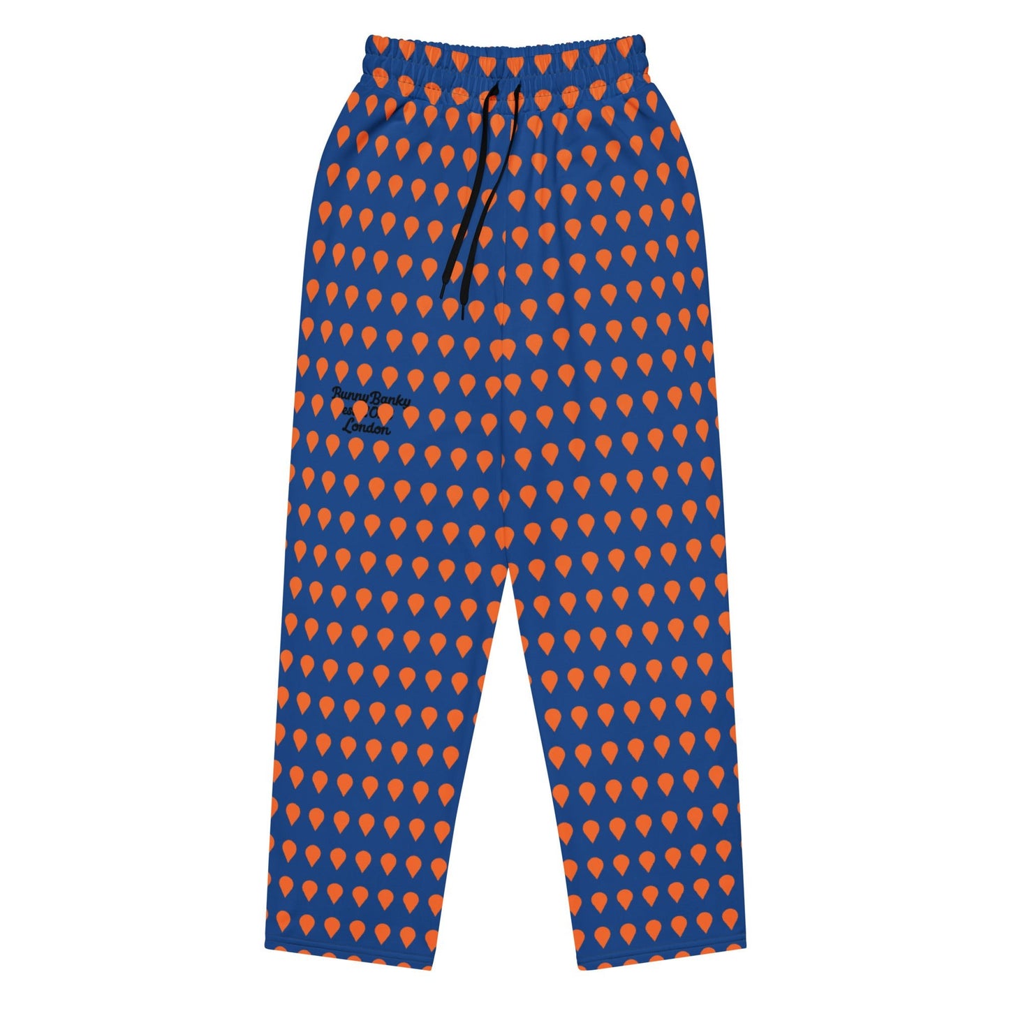 A close up of The Thames Flow Joggers, showing the wide-leg, relaxed silhouette and the orange drop print on the deep navy blue background, and the heritage signature in black