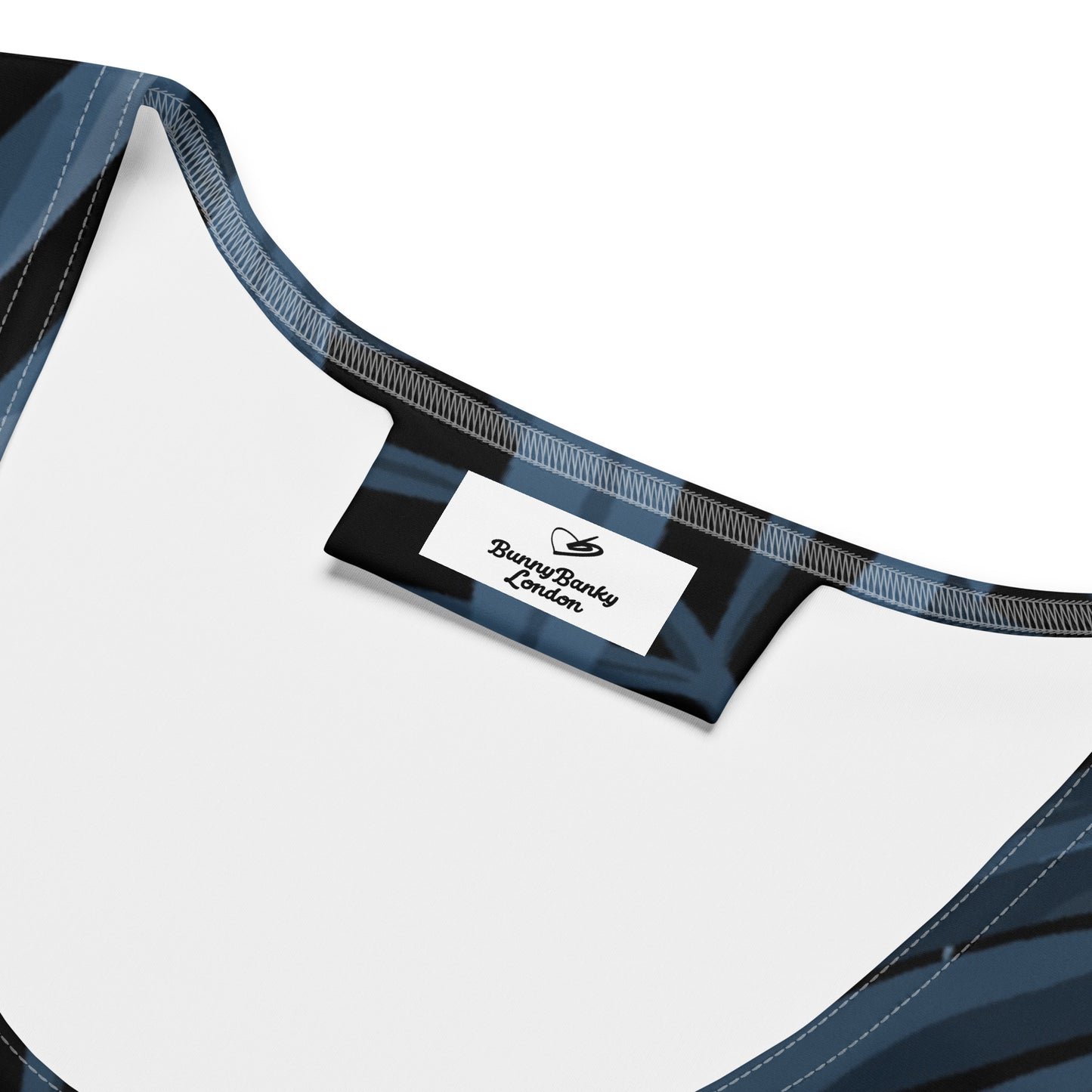 The Toulouse Performance Tank. A sleeveless racerback tank top featuring a dark navy blue and black tropical palm leaf pattern, displayed on a clean white background.