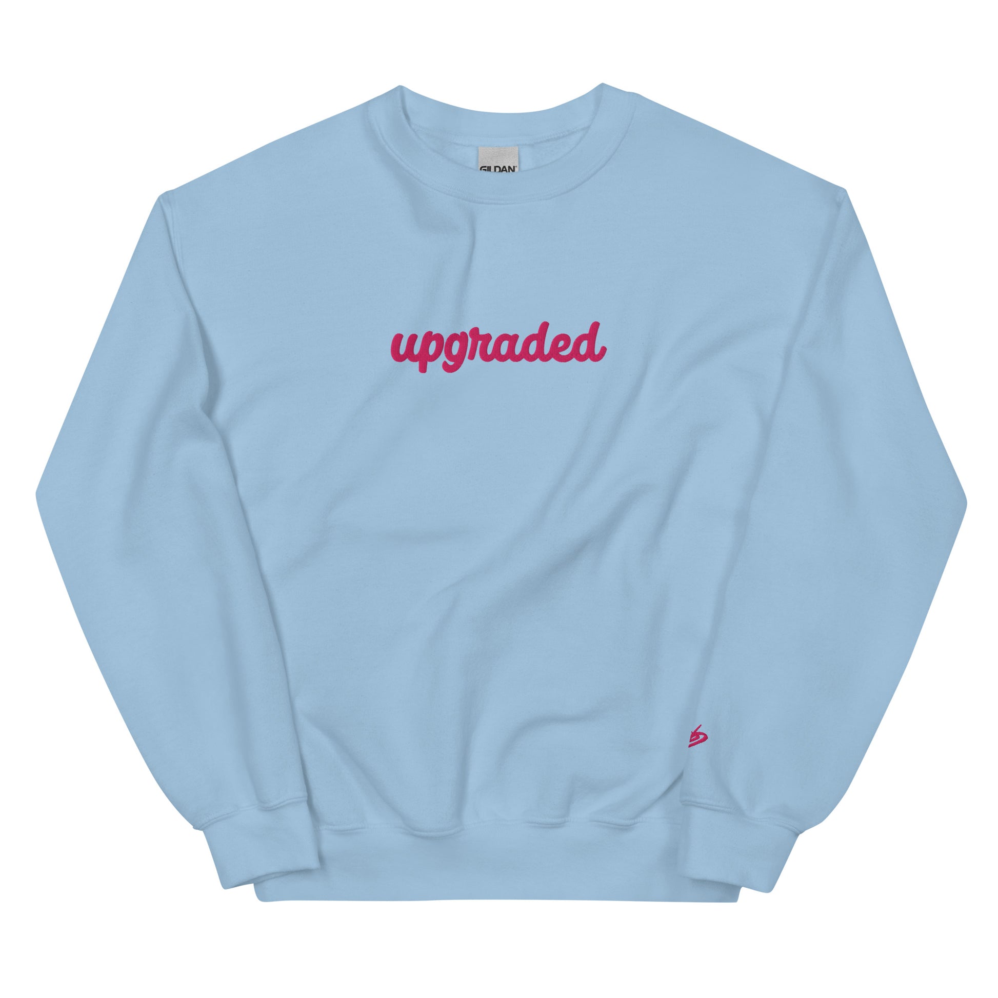 A close-up of The Upgrade Sweatshirt, highlighting the bold "Upgraded" text embroidered in fuschia on the chest, the soft air-jet spun fabric, and the detailed heritage logo print on the back.