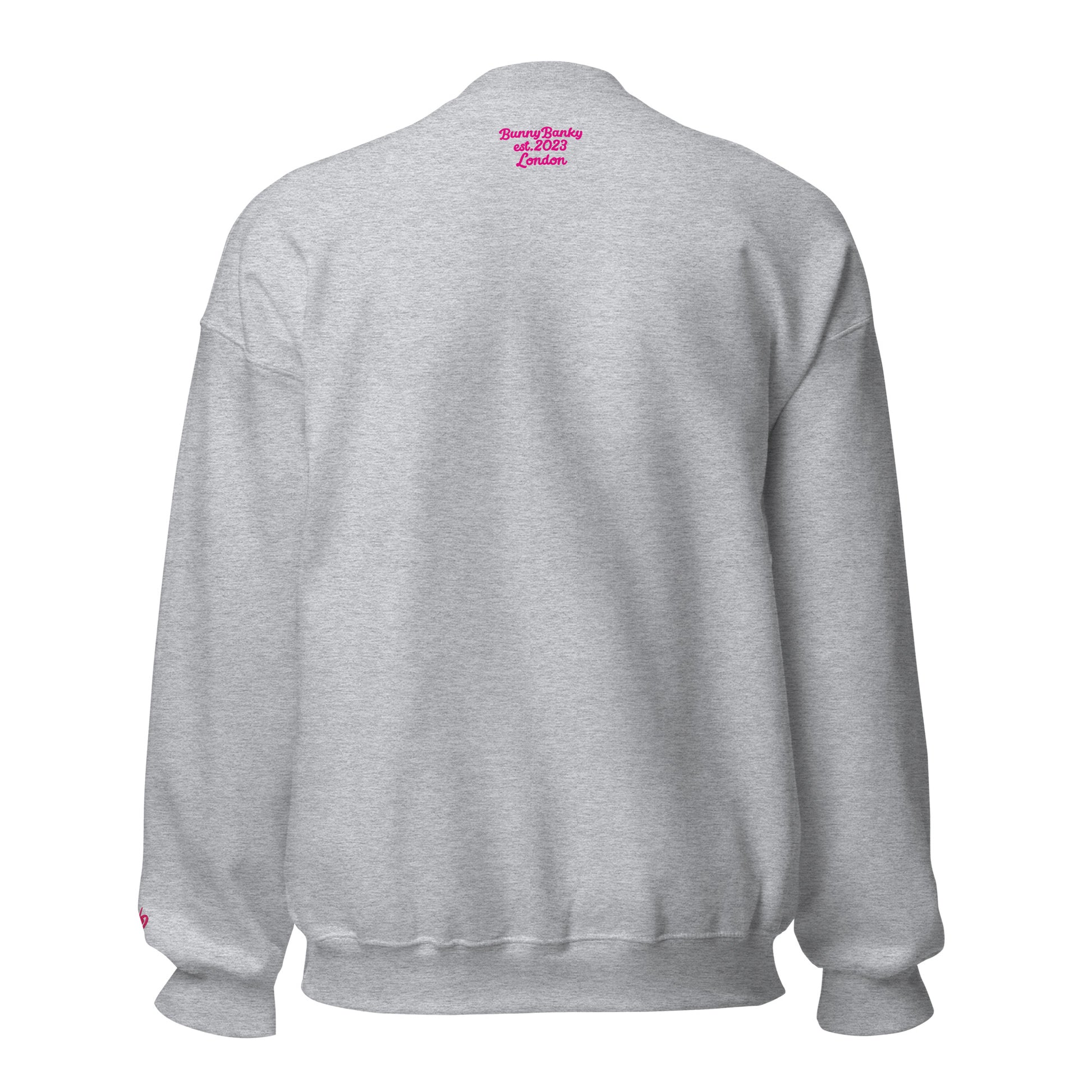A close-up of The Upgrade Sweatshirt, highlighting the bold "Upgraded" text embroidered in fuschia on the chest, the soft air-jet spun fabric, and the detailed heritage logo print on the back.
