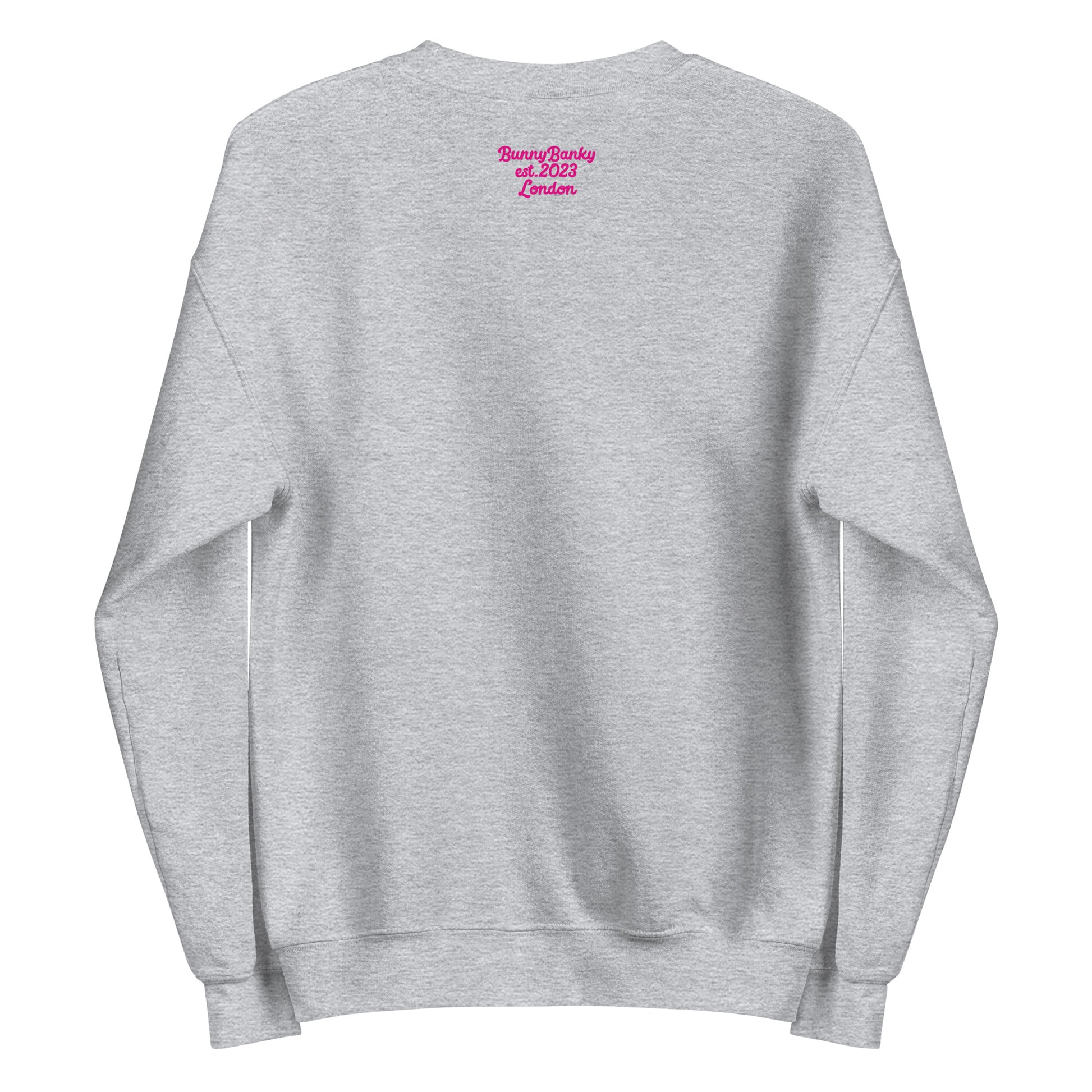 A close-up of The Upgrade Sweatshirt, highlighting the bold "Upgraded" text embroidered in fuschia on the chest, the soft air-jet spun fabric, and the detailed heritage logo print on the back.