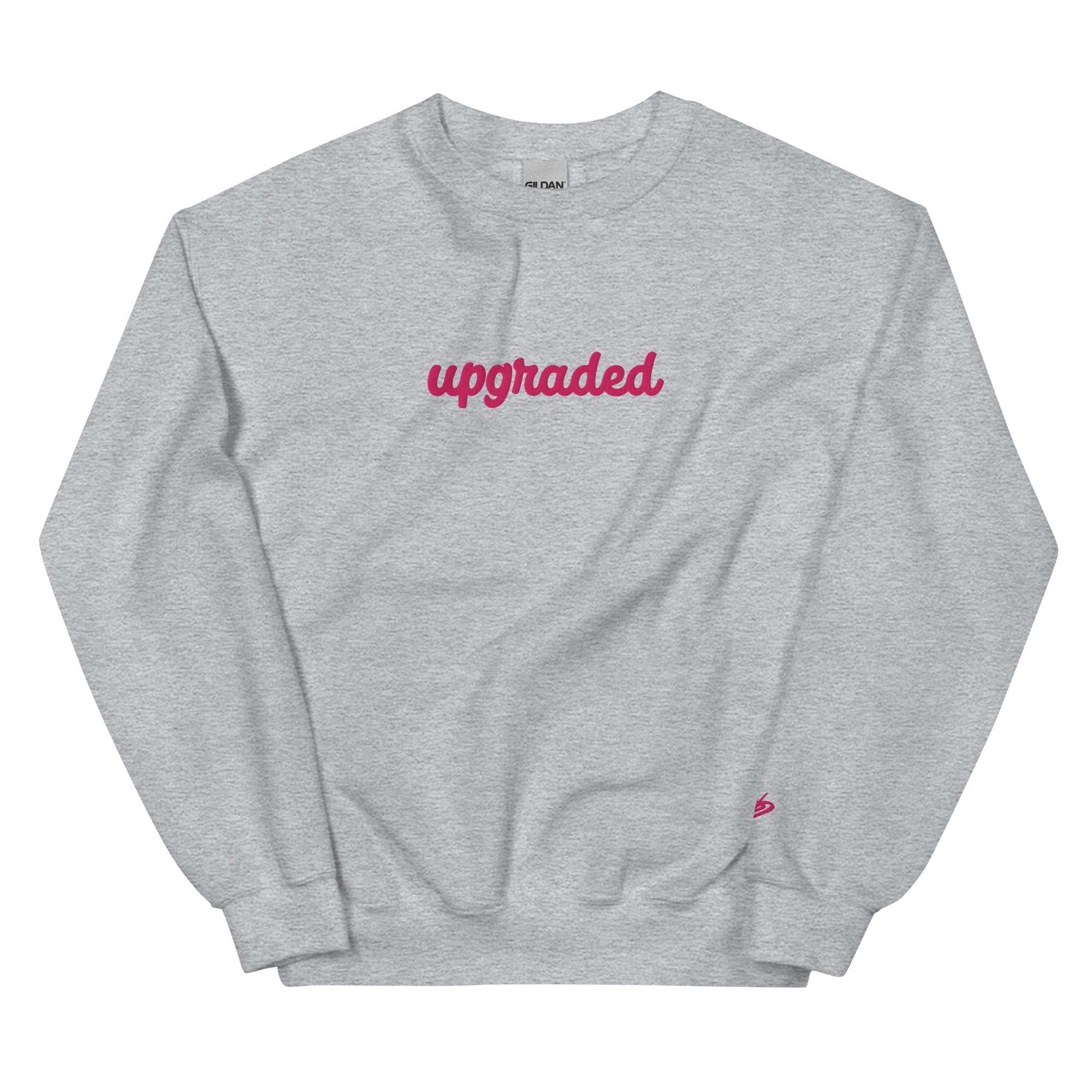A close-up of The Upgraded Sweatshirt, highlighting the bold Upgraded text embroidered in fuschia on the chest, the soft air-jet spun fabric, and the detailed heritage logo print on the back.