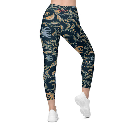 model wearing the Venice  high-waisted sculpt leggings featuring an intricate gold and slate-blue floral filigree print over a dark blue base
