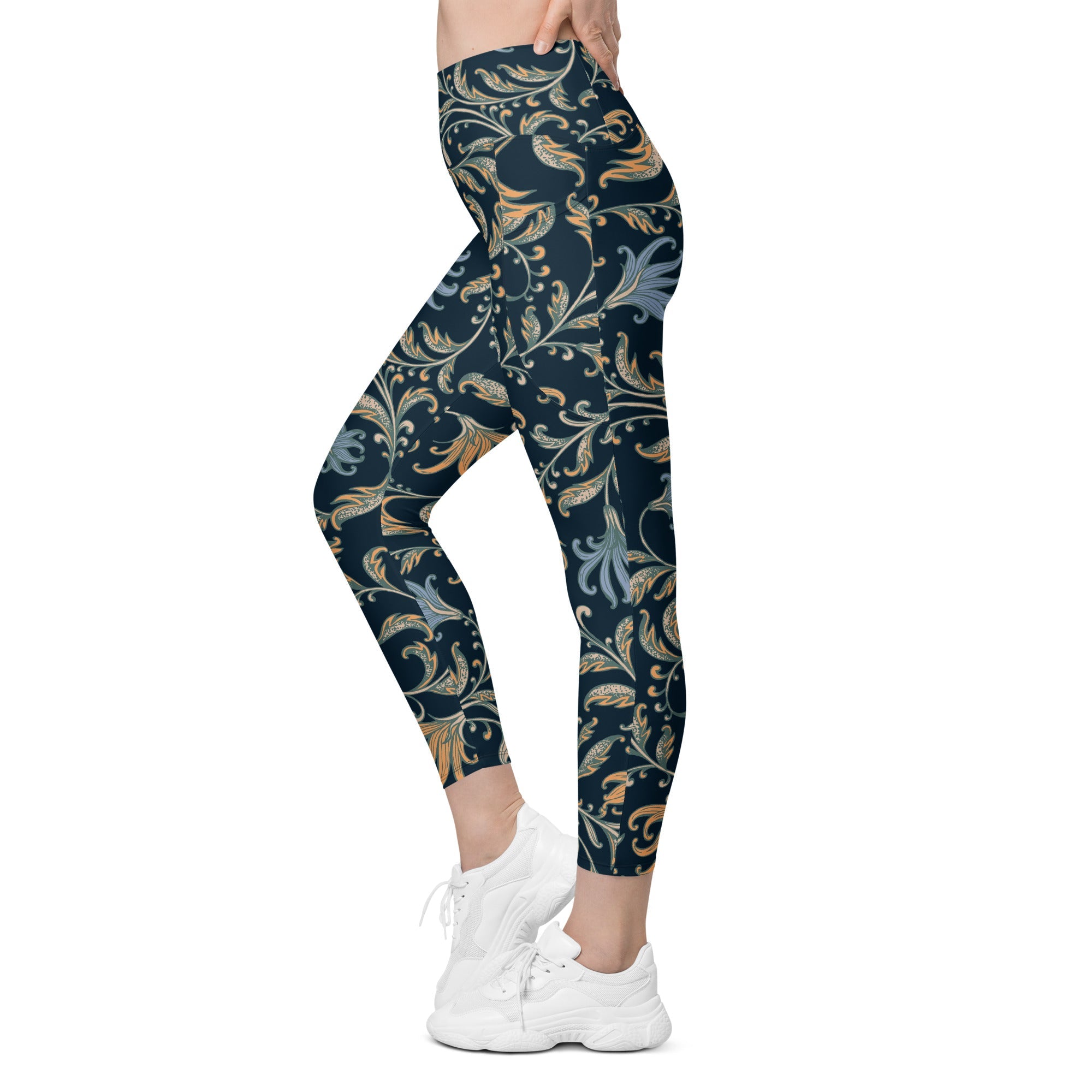 model wearing the Venice  high-waisted sculpt leggings featuring an intricate gold and slate-blue floral filigree print over a dark blue base