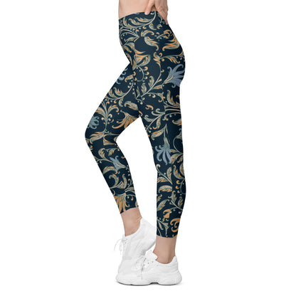 model wearing the Venice  high-waisted sculpt leggings featuring an intricate gold and slate-blue floral filigree print over a dark blue base