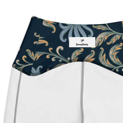 close up o the Venice  high-waisted sculpt leggings featuring an intricate gold and slate-blue floral filigree print over a dark blue base 
