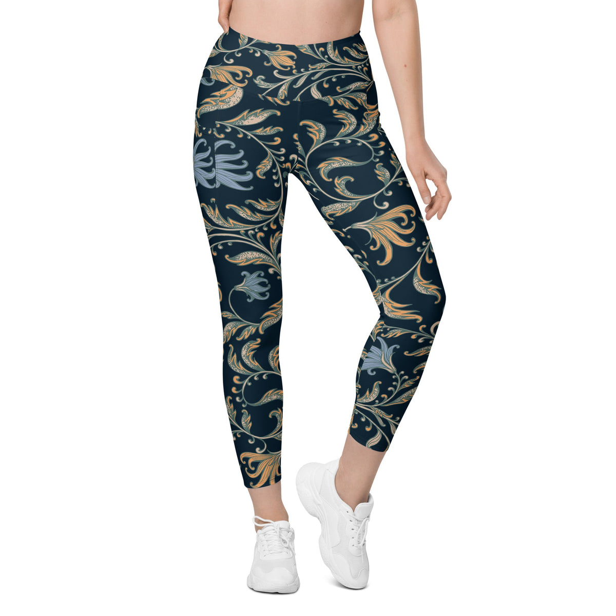 model wearing the Venice  high-waisted sculpt leggings featuring an intricate gold and slate-blue floral filigree print over a dark blue base