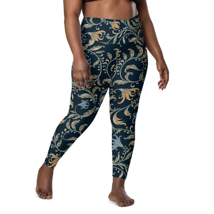 model wearing the Venice  high-waisted sculpt leggings featuring an intricate gold and slate-blue floral filigree print over a dark blue base