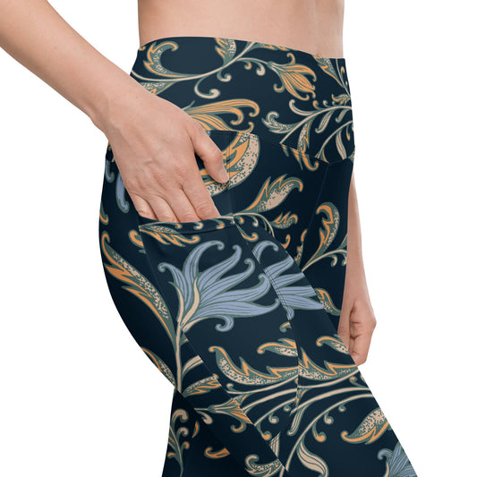 model wearing the Venice  high-waisted sculpt leggings featuring an intricate gold and slate-blue floral filigree print over a dark blue base
