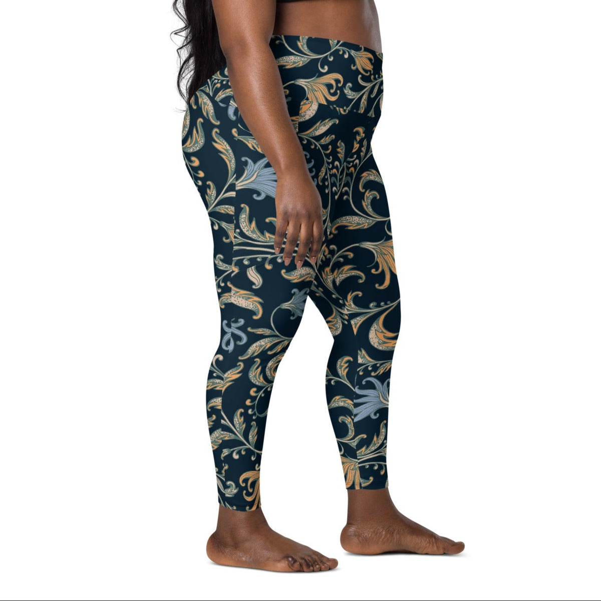 model wearing the Venice  high-waisted sculpt leggings featuring an intricate gold and slate-blue floral filigree print over a dark blue base