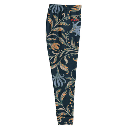 close up of the Venice slim fit high-waisted athletic joggers with a dark navy blue background and an intricate botanical pattern in gold, beige, and light blue. The joggers feature a small red logo on the left hip.