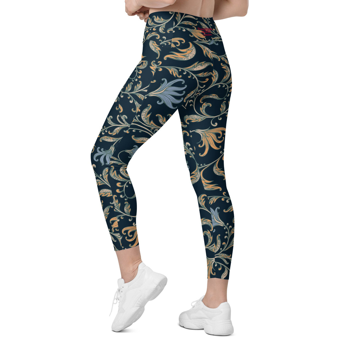 model wearing the Venice  high-waisted sculpt leggings featuring an intricate gold and slate-blue floral filigree print over a dark blue base
