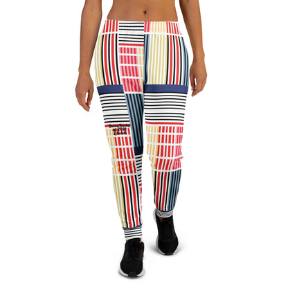 A model wearing The Vienna Slim Joggers, showing the narrow fit, cuffed ankles, and the Art Nouveau graphic print in primary colors.