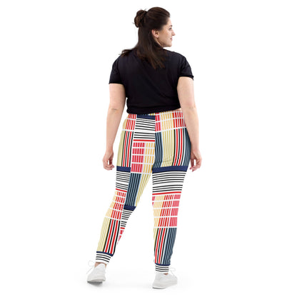 A model wearing The Vienna Slim Joggers, showing the narrow fit, cuffed ankles, and the Art Nouveau graphic print in primary colors.