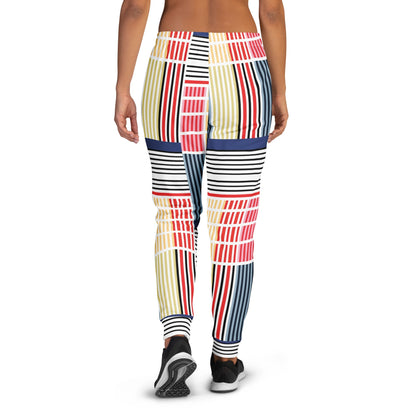 A model wearing The Vienna Slim Joggers, showing the narrow fit, cuffed ankles, and the Art Nouveau graphic print in primary colors.