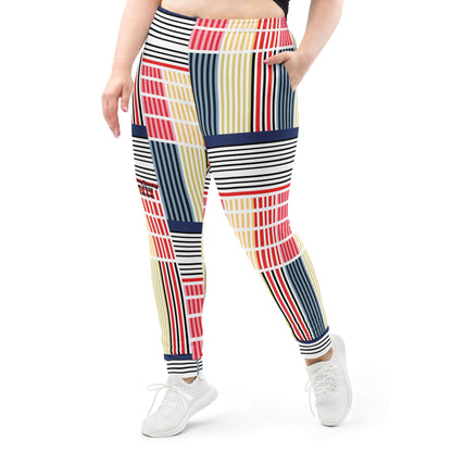 A model wearing The Vienna Slim Joggers, showing the narrow fit, cuffed ankles, and the Art Nouveau graphic print in primary colors.